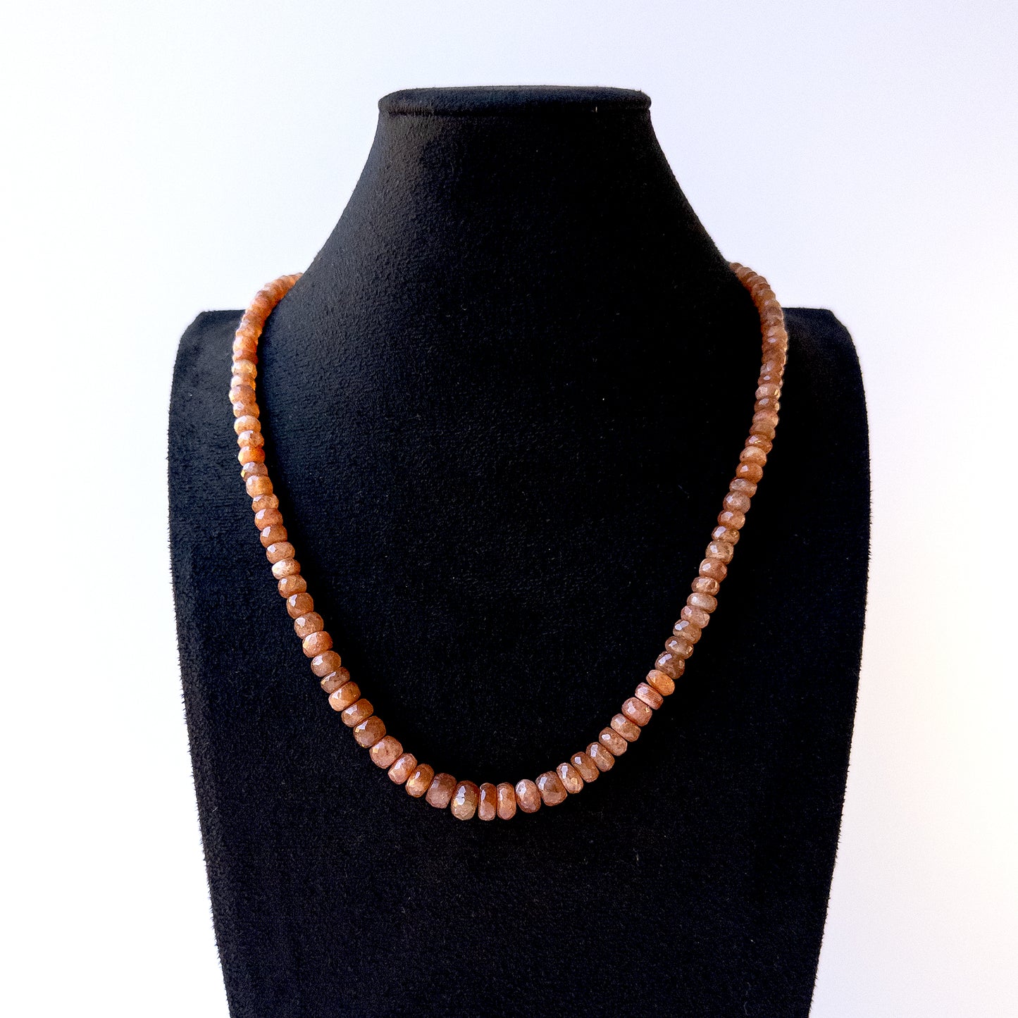 Authentic Sunstone stone beads showcasing peach shimmer and fine faceted rondelle detailing for designers.