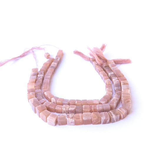 Genuine sunstone stone beads with polished smooth cube shaping, ideal for DIY jewellery and artisan beadwork.