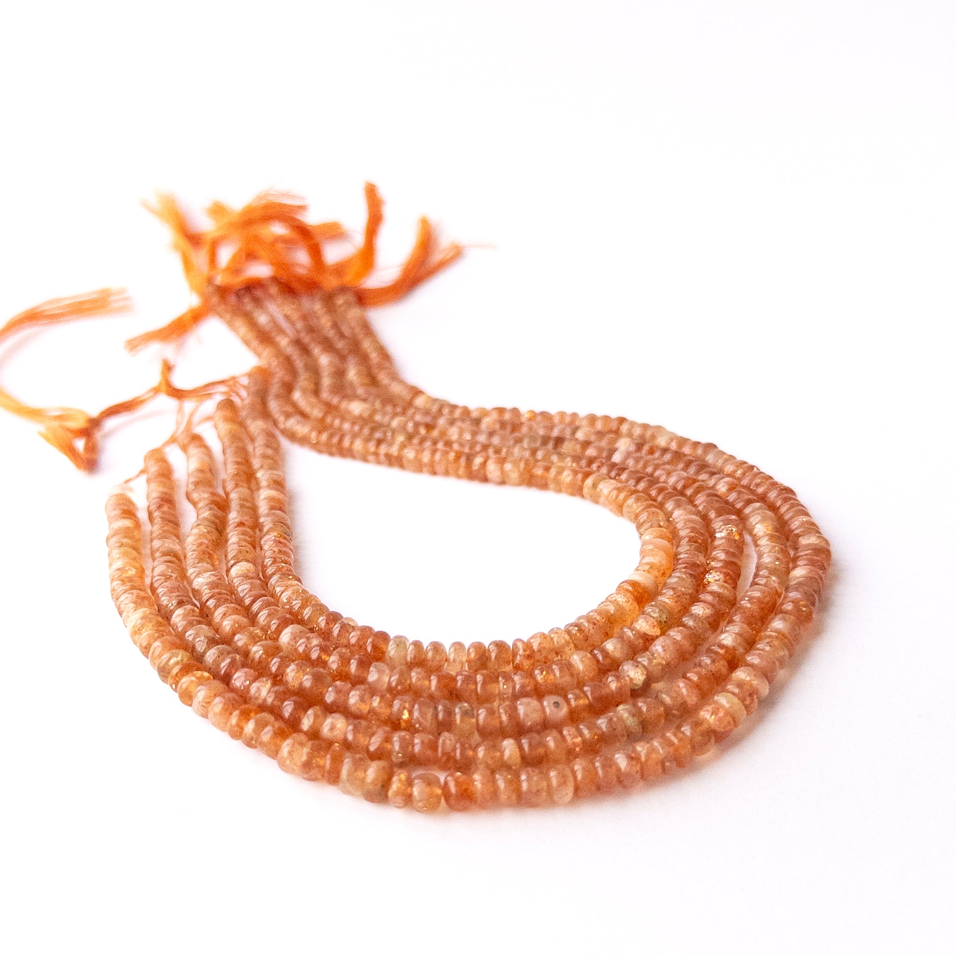Sunstone smooth rondelle beads in 4.9–5.2mm, showing warm peach and golden tones for handmade jewellery components.