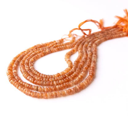 Close‑up of Sunstone smooth rondelle beads highlighting natural shimmer, colour variation, and quality for DIY jewellery making.