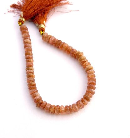 Natural sunstone smooth wheel beads with warm peach tones for DIY jewellery. 