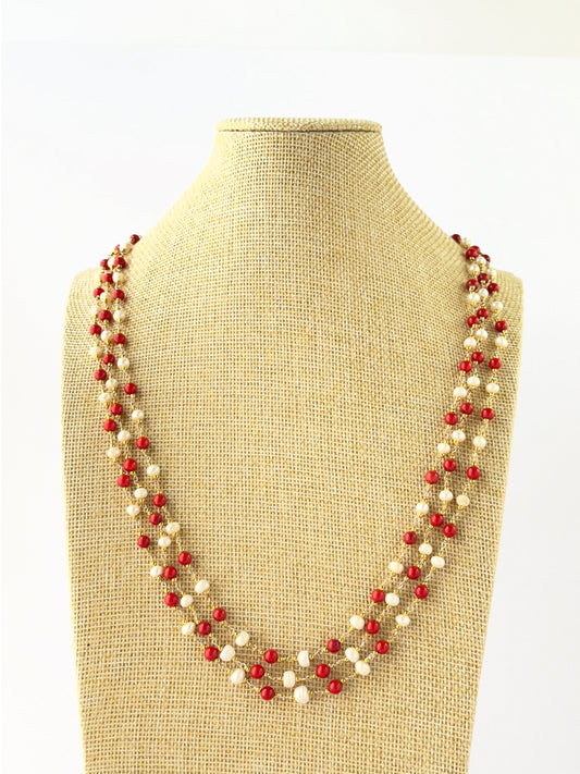Three-strand necklace combining smooth round Taiwan coral and freshwater pearl 5mm beads in layered lengths.