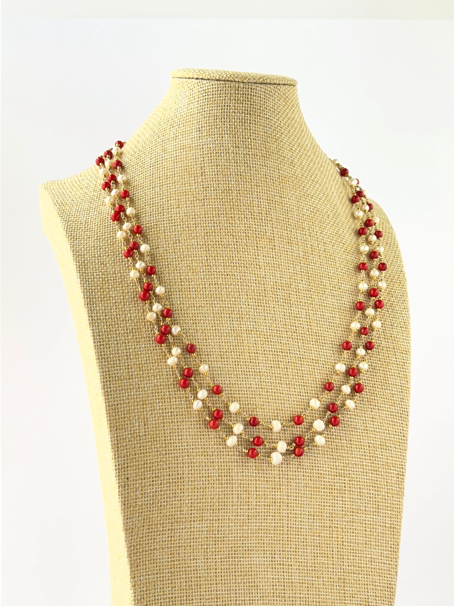 Layered coral and freshwater pearl necklace crafted with smooth round 5mm beads and adjustable fit.