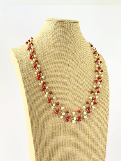 Layered coral and freshwater pearl necklace crafted with smooth round 5mm beads and adjustable fit.