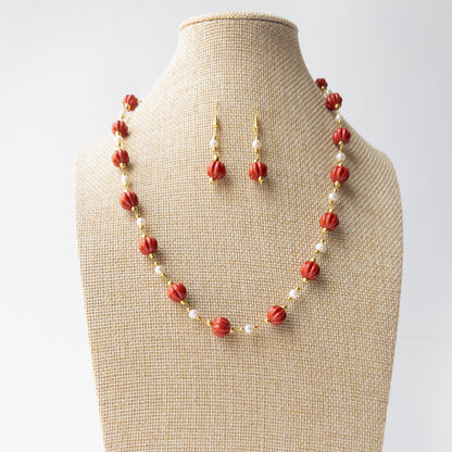Authentic Taiwan Coral jewellery showcasing detailed curved pumpkin carving and a coordinated necklace and earring design.