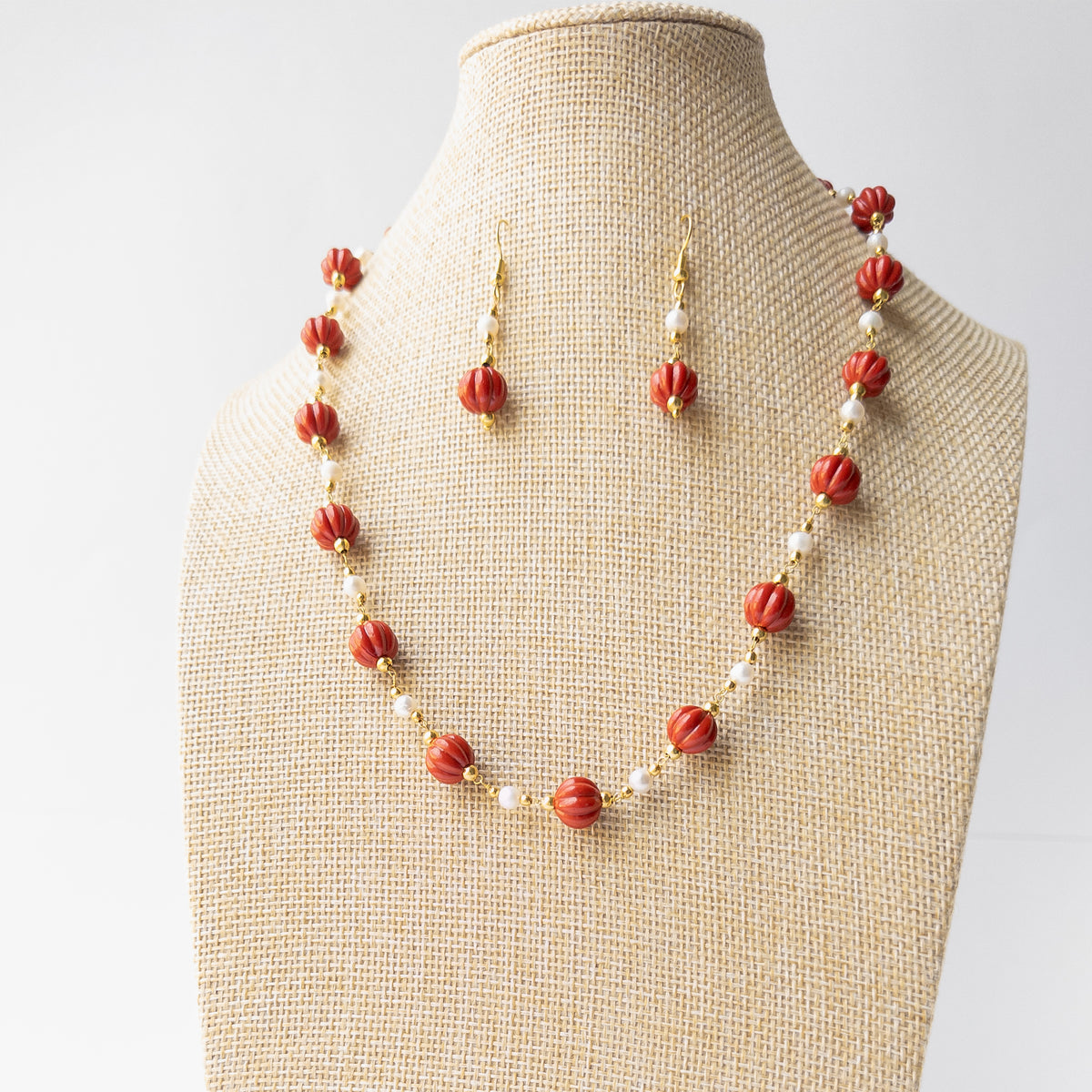 Genuine Taiwan Coral gemstone necklace set displaying rich colour, intricate carving and timeless handcrafted appeal.
