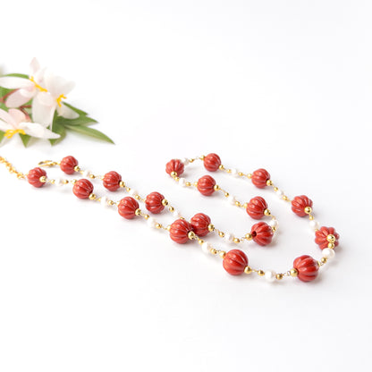 Handmade jewellery featuring carved Taiwan Coral beads complemented by luminous pearl accents and gold-tone findings.