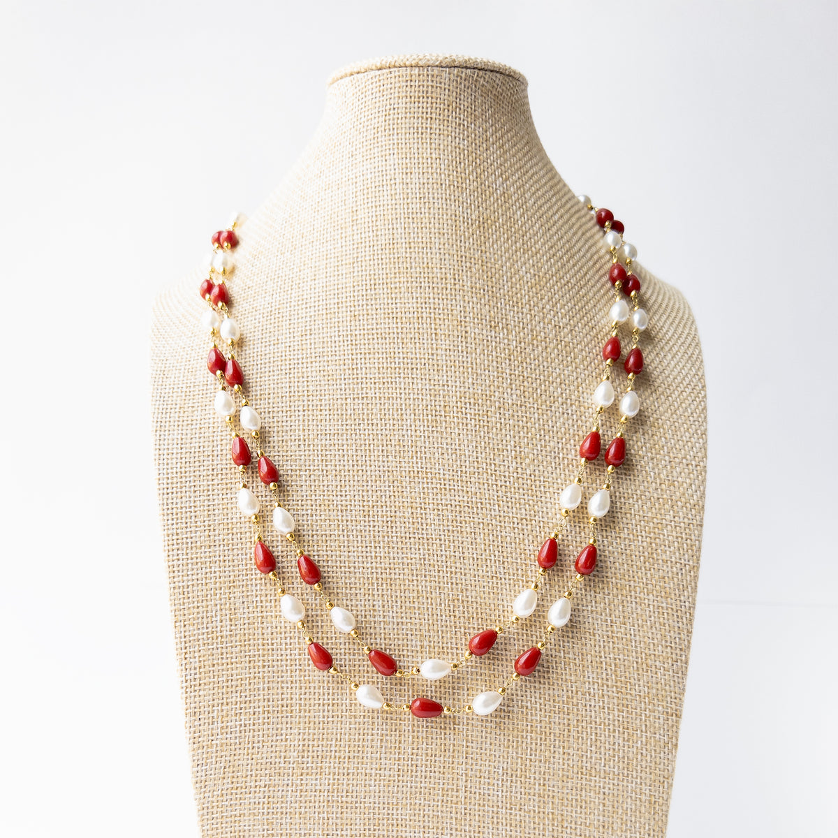 Genuine Taiwan Coral and Freshwater Pearl necklace showcasing smooth teardrop gemstones in a graceful two-strand design.