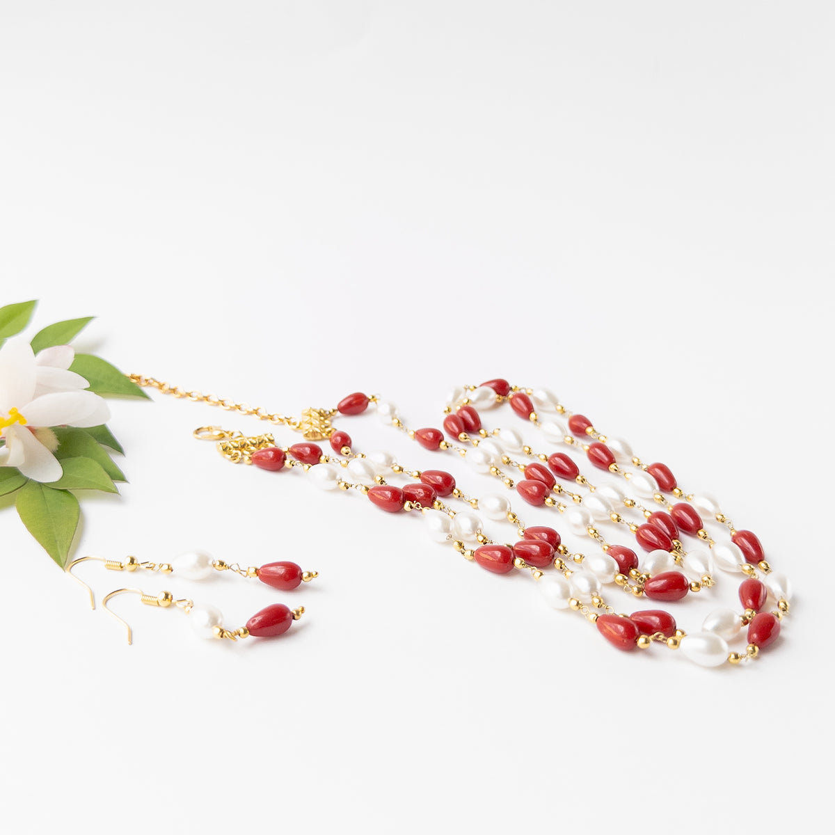 Taiwan Coral and Freshwater Pearl necklace and earring set featuring smooth teardrop beads in vibrant red and white tones with elegant gold-tone accents.