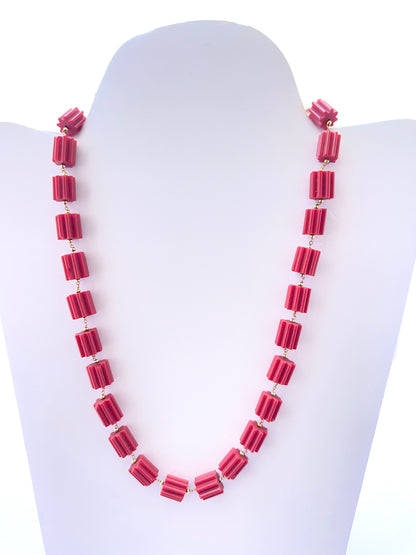 Taiwan coral necklace featuring faceted cylinder beads in bold red tones.