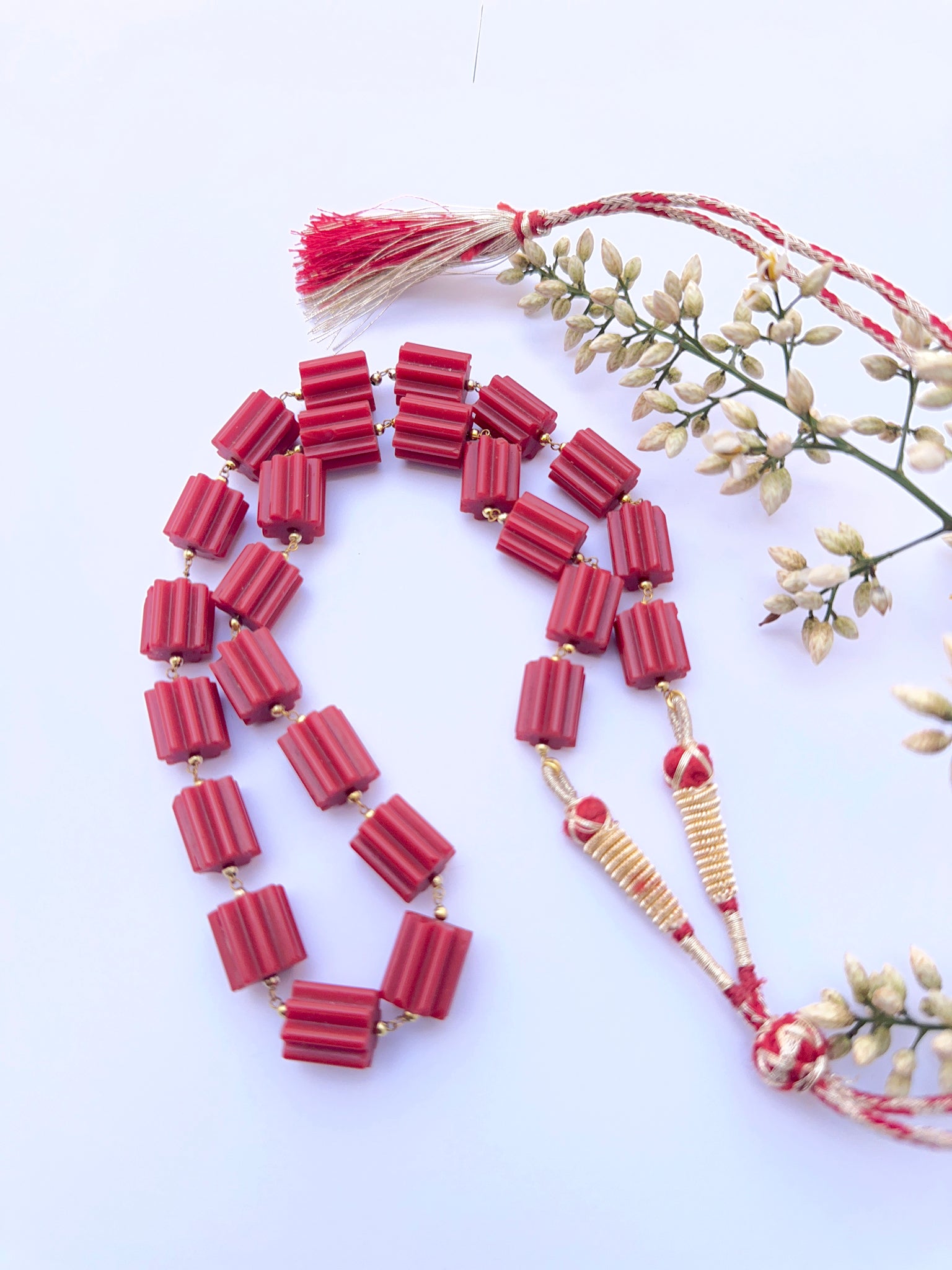 Coral necklace with faceted beads showing strong colour and natural texture.