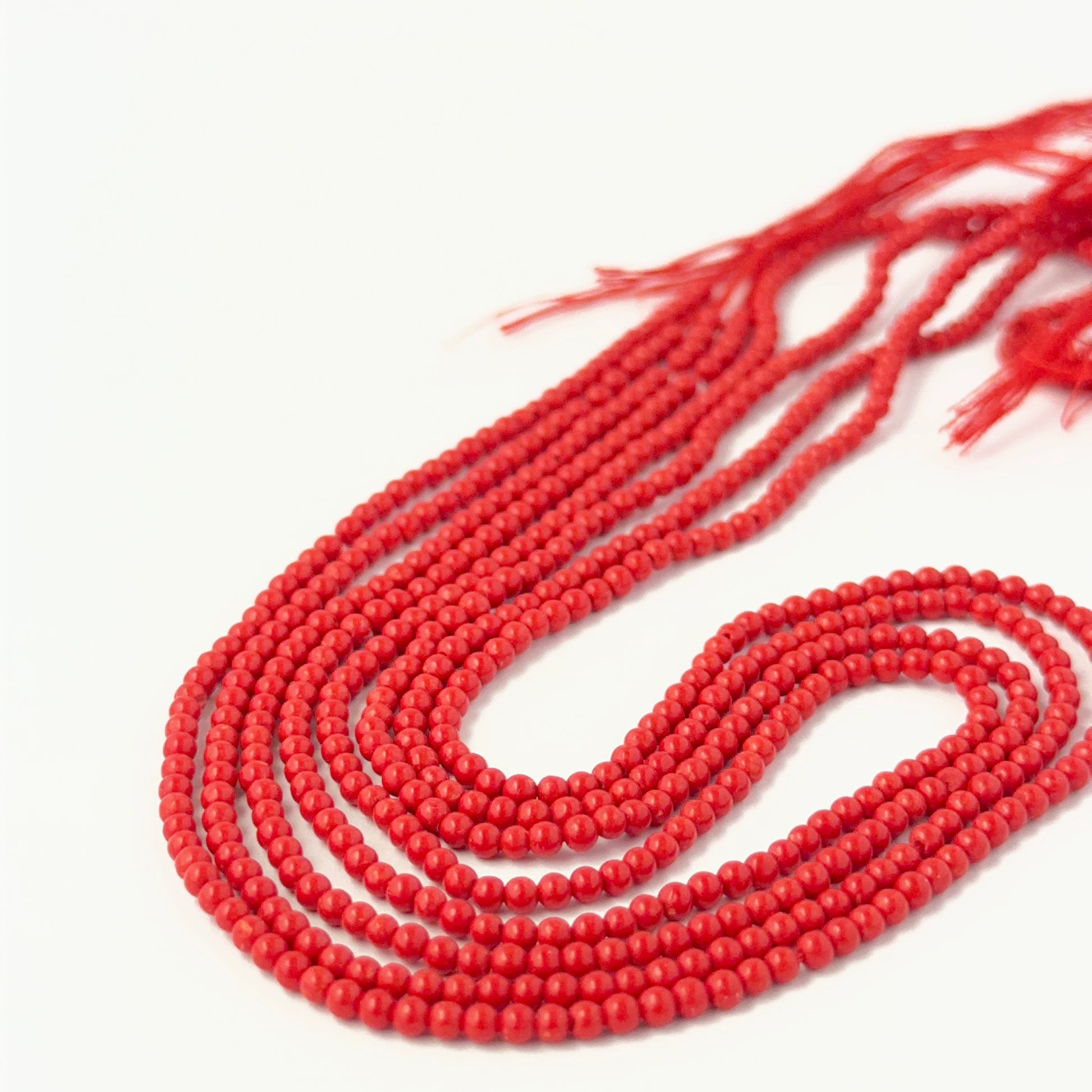 Smooth round Taiwan Coral beads showing bright colour and consistent handmade jewellery component quality.