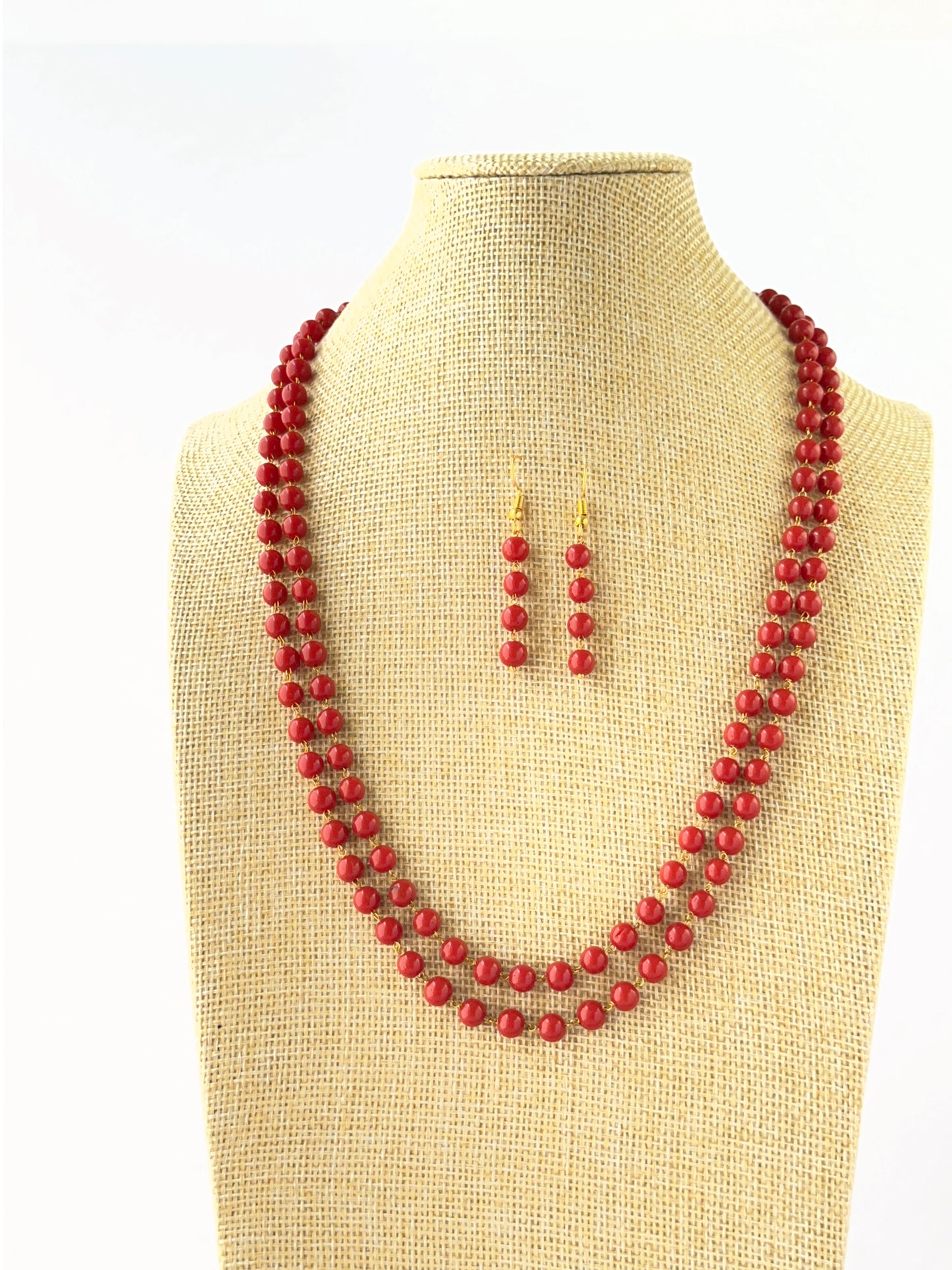 Layered coral necklace crafted with smooth round 6mm beads and adjustable fit.