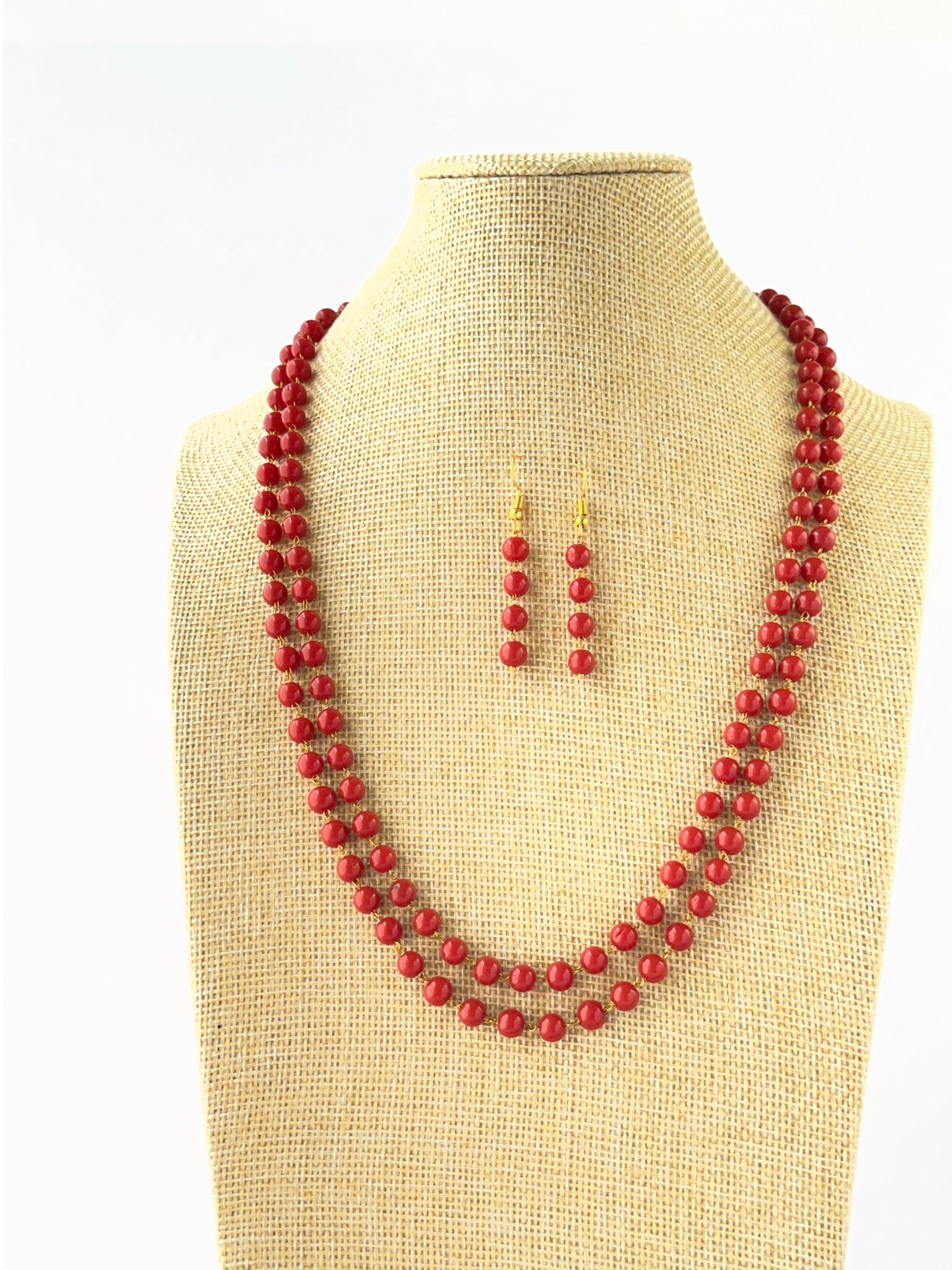 Layered coral necklace crafted with smooth round 6mm beads and adjustable fit.