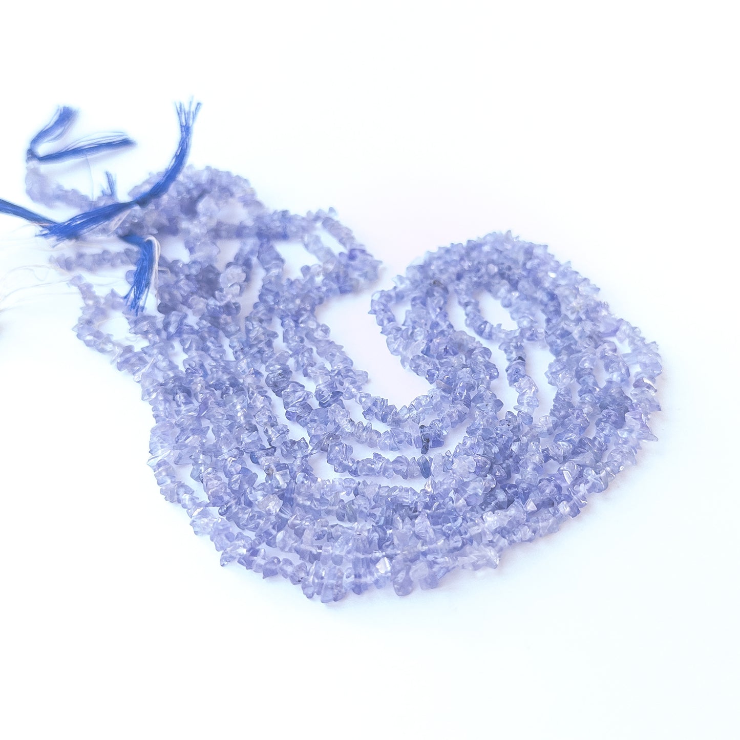 Tanzanite chip gemstone beads in 3.5–4.5mm size arranged on a 33cm strand with soft violet‑blue shine.