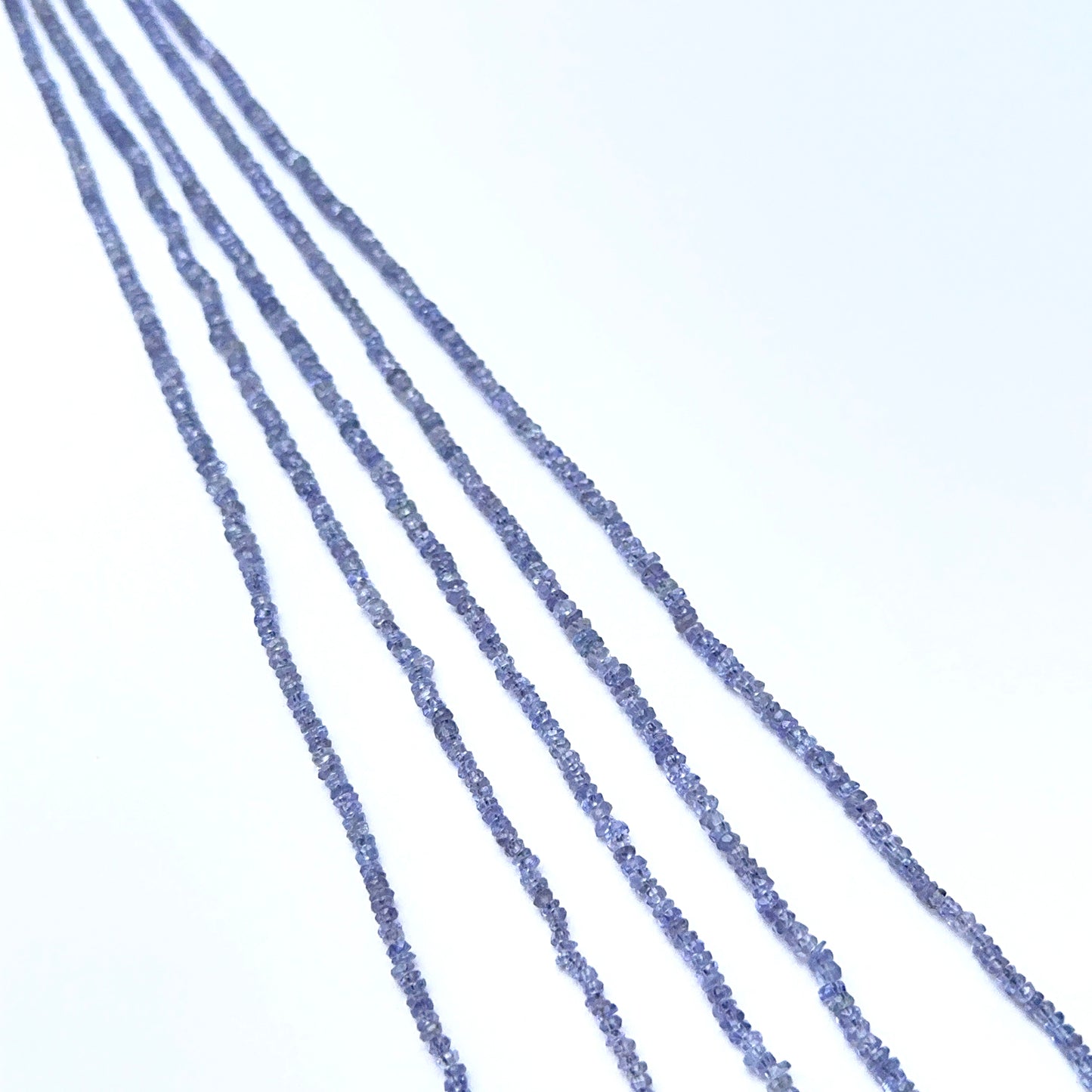 Faceted tanzanite beads with fine rondelles arranged in an elegant layout.