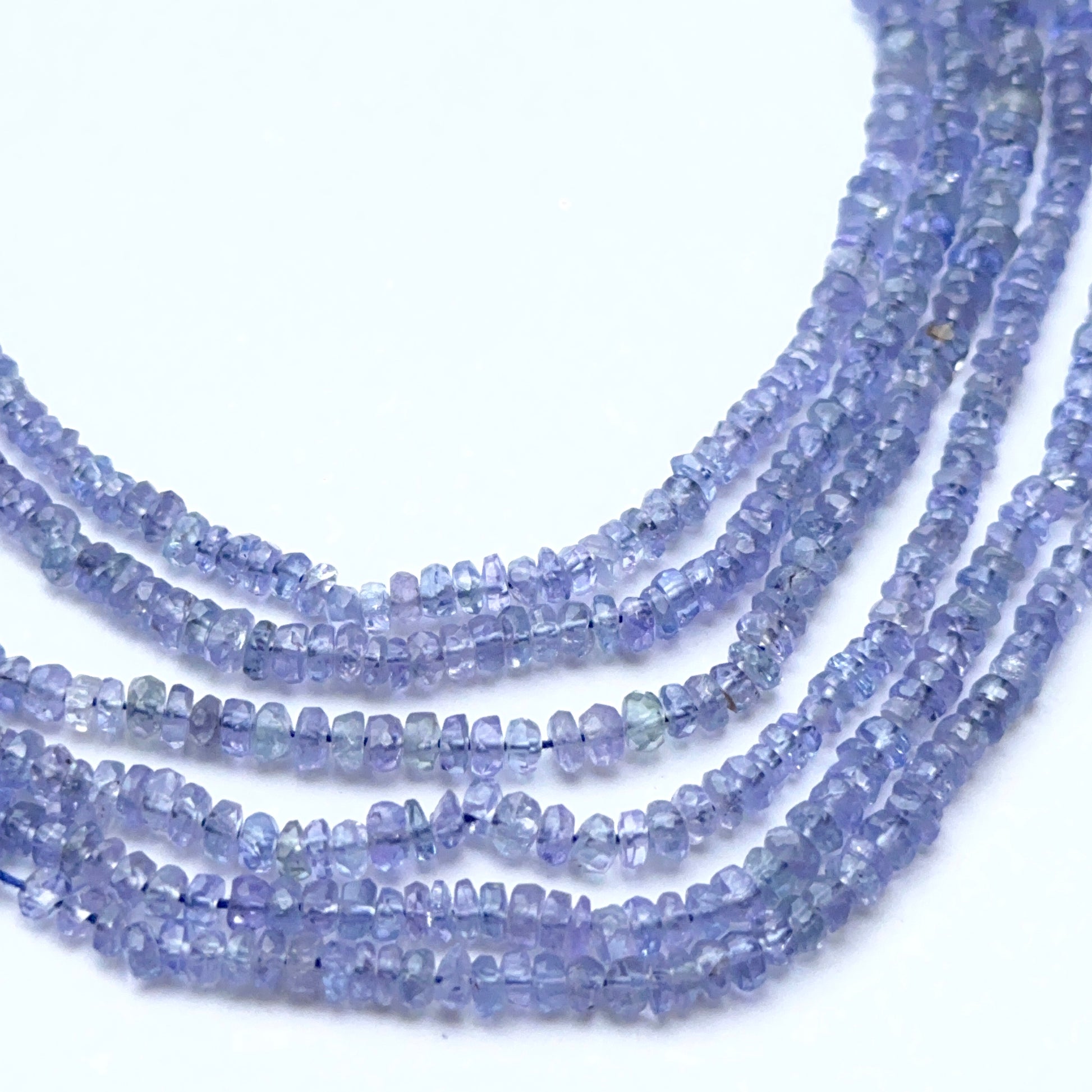 Natural tanzanite strand with faceted rondelles showing bright blue‑violet tones.