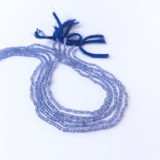 Genuine tanzanite stone beads with sparkling faceted rondelle shaping, ideal for DIY jewellery and artisan beadwork.