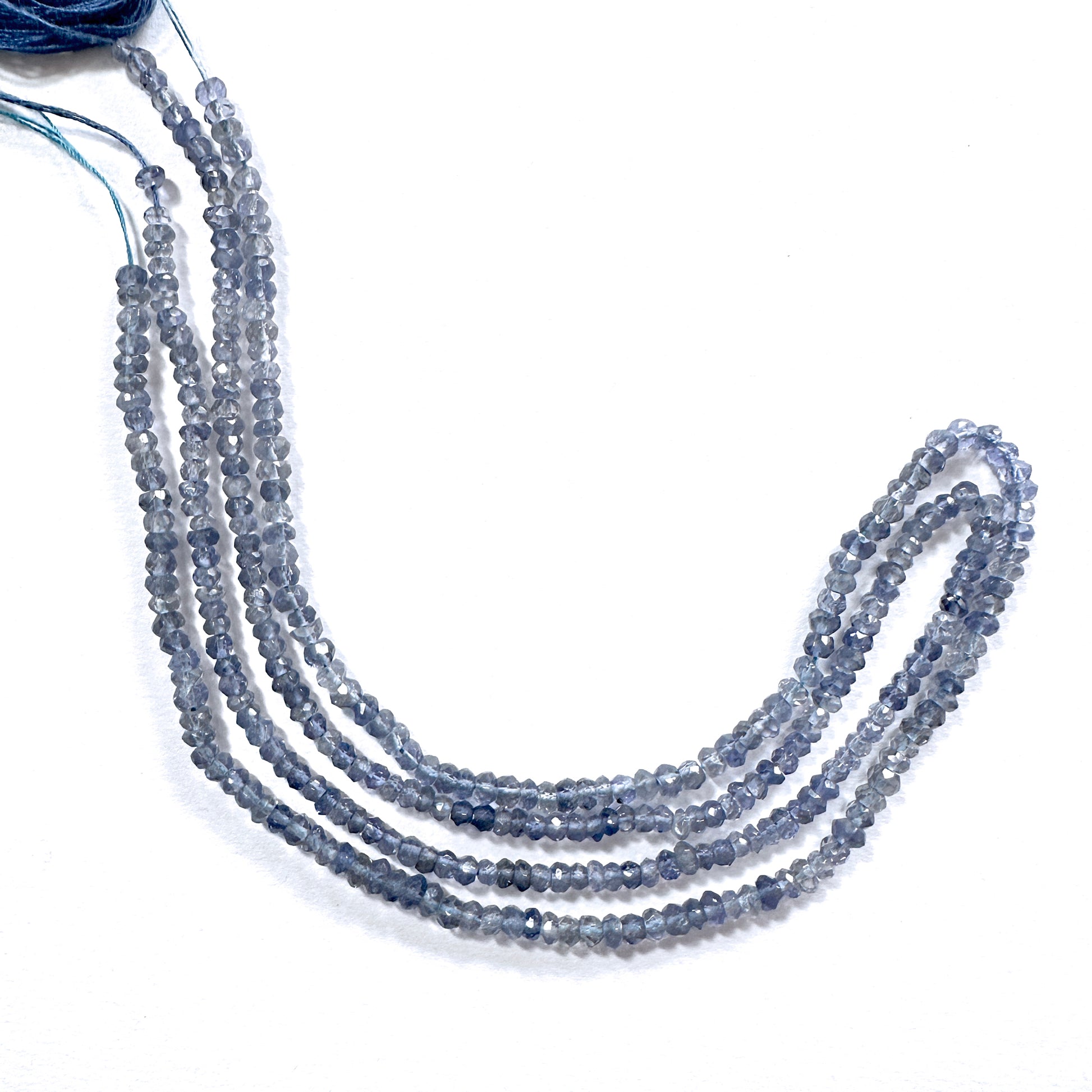 High-grade tanzanite rondelle beads in 3.5mm size, arranged in a luminous strand.