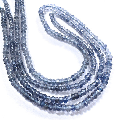 Close-up of 3.5mm tanzanite rondelle beads showing deep violet hues and precision faceting.