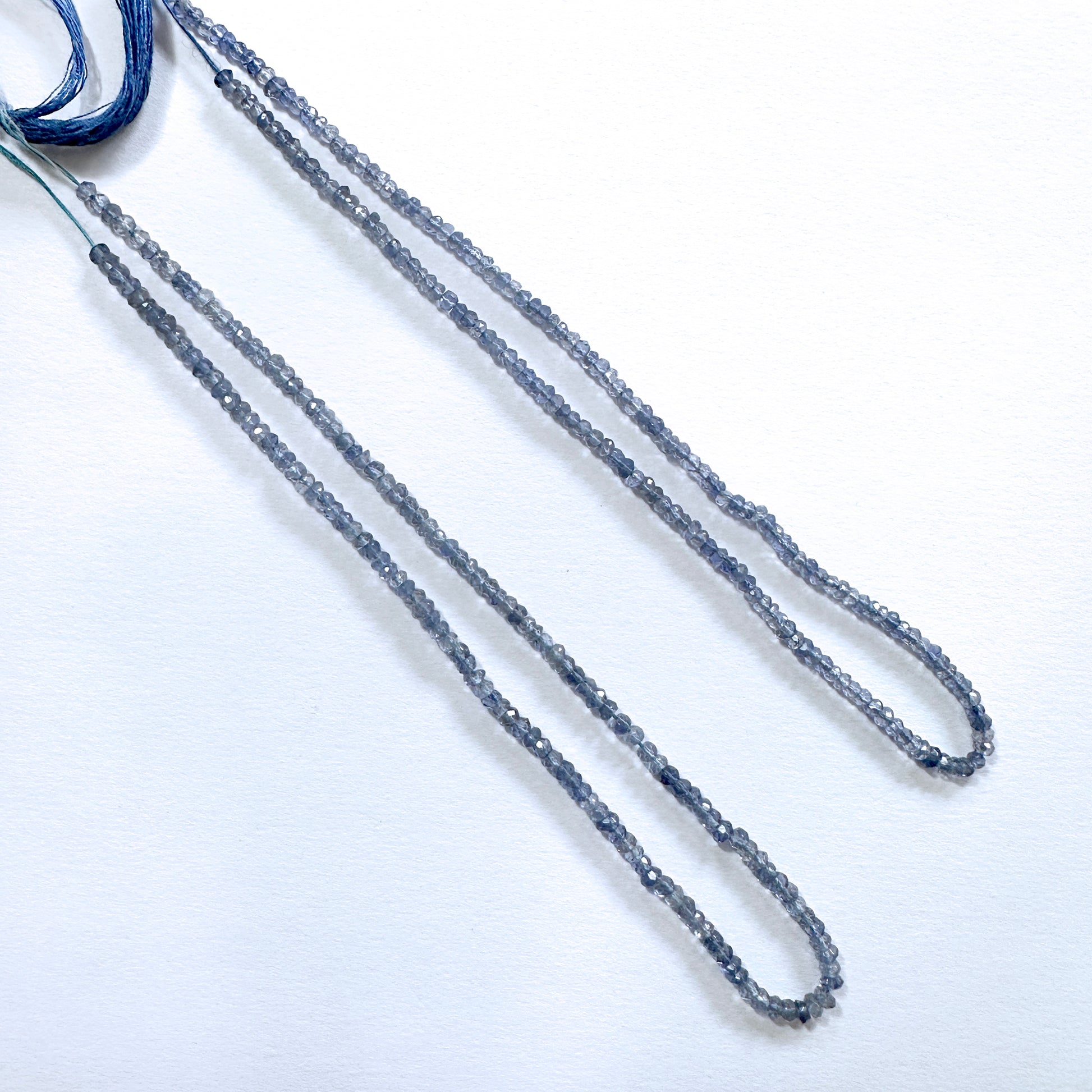 Tanzanite gemstone beads in rondelle cut shimmer with high clarity and consistent sizing.