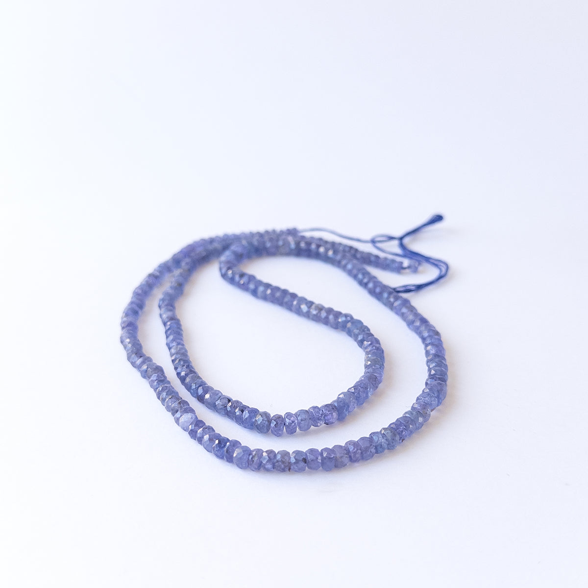 Sparkling Tanzanite faceted rondelle beads in mixed 4.1–6.2mm sizes for handmade jewellery components.