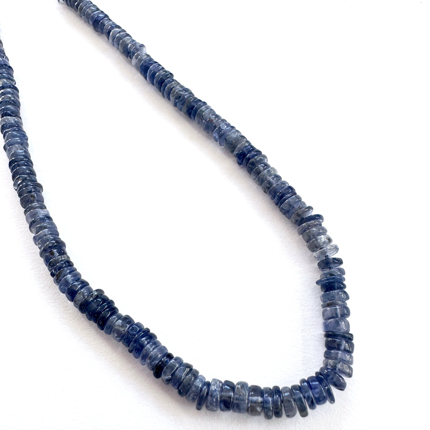 Close-up of Tanzanite smooth wheel beads with vivid violet-blue tones and polished finish.