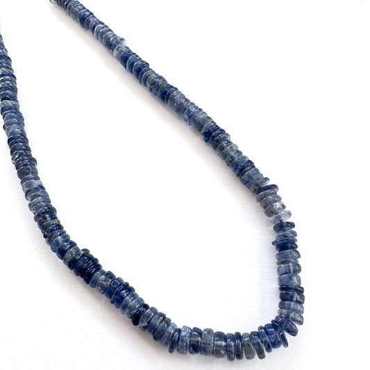 Close-up of Tanzanite smooth wheel beads with vivid violet-blue tones and polished finish.