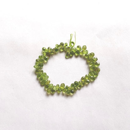 Vibrant green faceted Peridot pear-shaped briolette beads on a 20cm strand with eye-catching sparkle.
