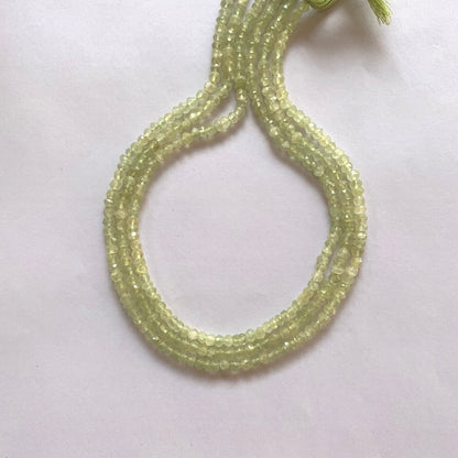 Close-up of Prehnite gemstone beads showing their 4.0–4.2mm size and brilliant faceted cut.