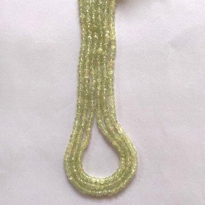 Macro shot of Prehnite beads highlighting their clarity, symmetry, and subtle green glow.
