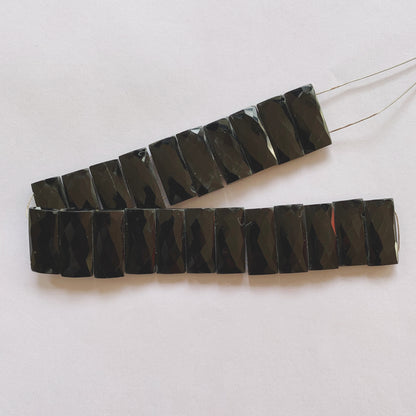 Black Onyx rectangles reflecting light with a glass-like polish, arranged in a neat 20cm strand.