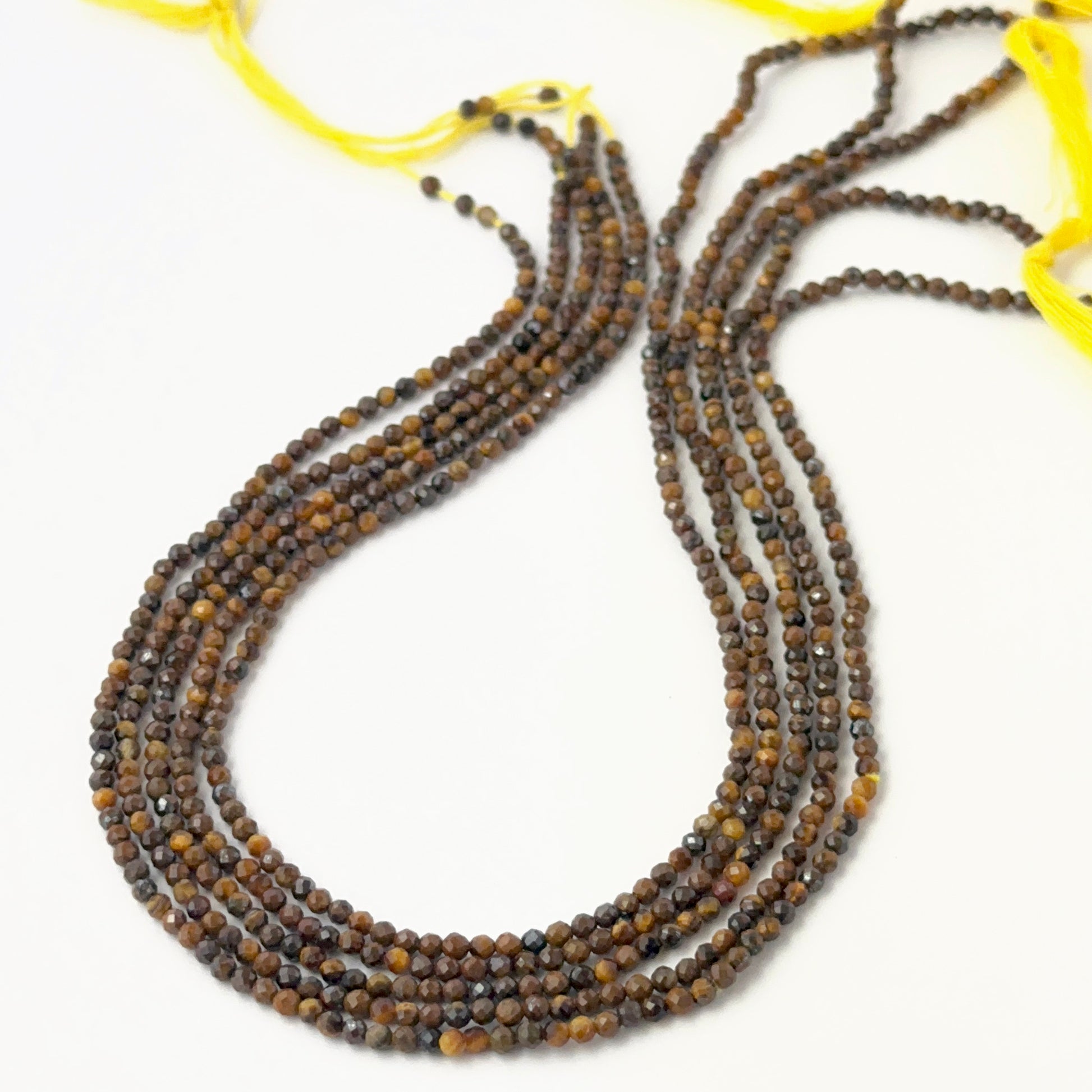 Micro faceted Tiger Eye rondelles showing warm golden tones and consistent handmade jewellery component quality.