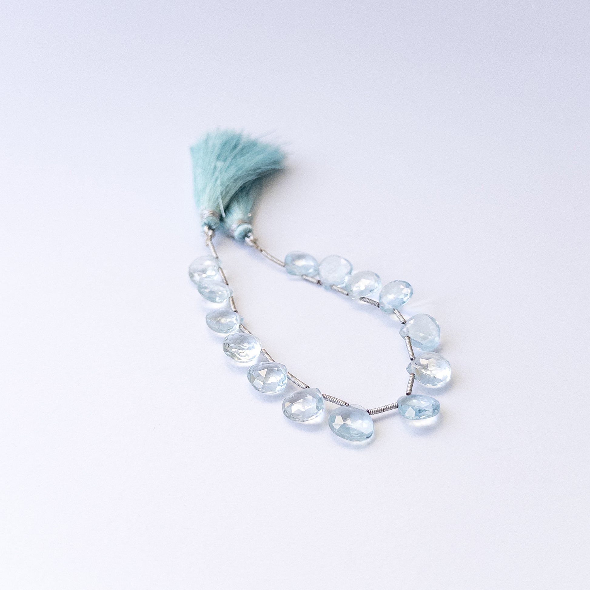 Natural Topaz stone beads with polished faceted briolette shapes, perfect for artisan jewellery components.
