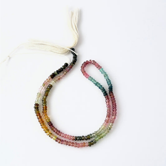 Tourmaline faceted rondelle gemstone beads showing vibrant mixed colours and sparkle for DIY jewellery makers.