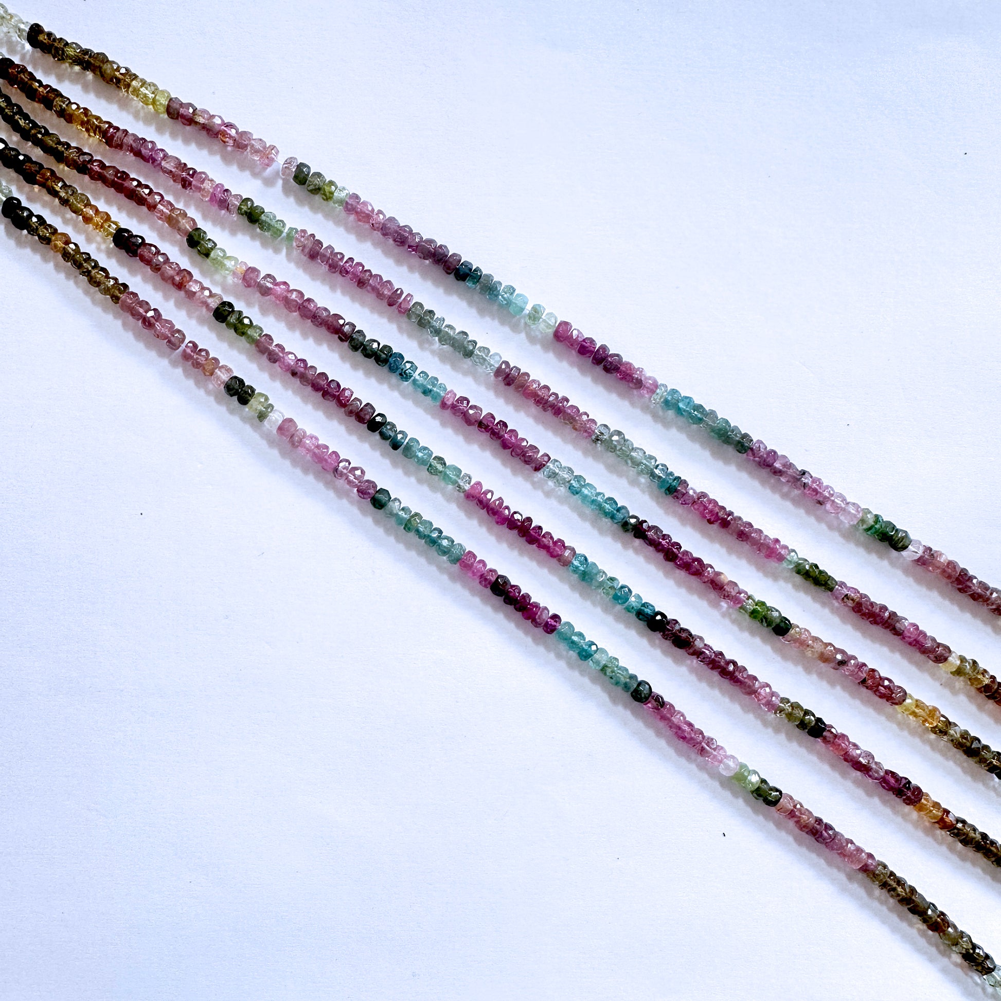 Multicolour Tourmaline gemstones in  rondelle cut, reflecting light beautifully with consistent clarity.