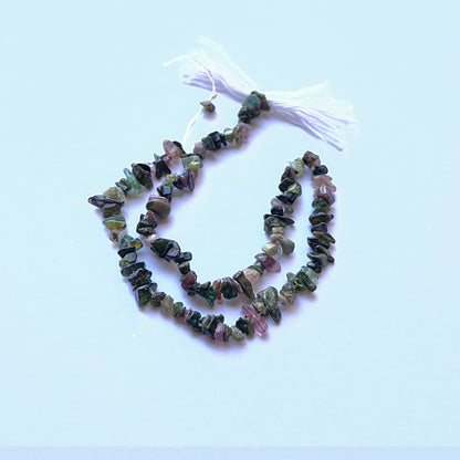 Tourmaline rough chip natural gemstone beads in mixed earthy colours arranged on a 25cm strand for handmade jewellery components.