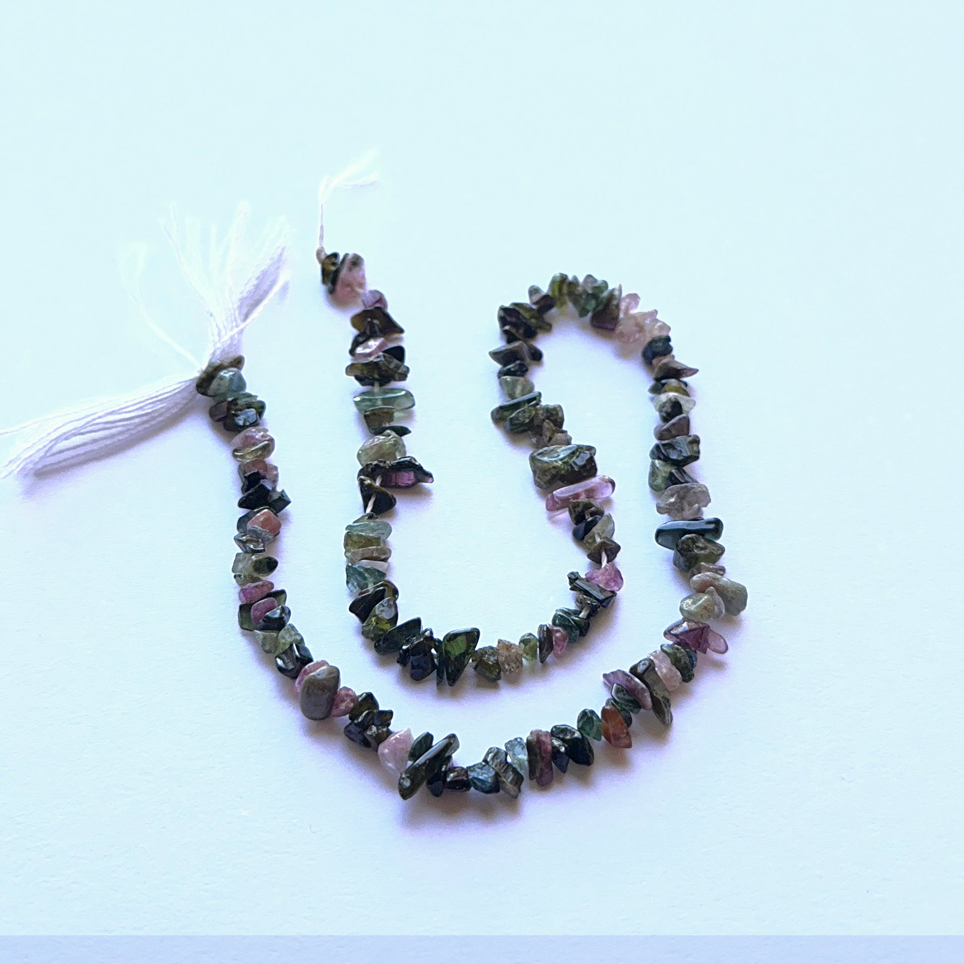 Close‑up of 4–5mm Tourmaline stone beads showing raw texture and organic shapes ideal for natural gemstone beads for DIY jewellery.