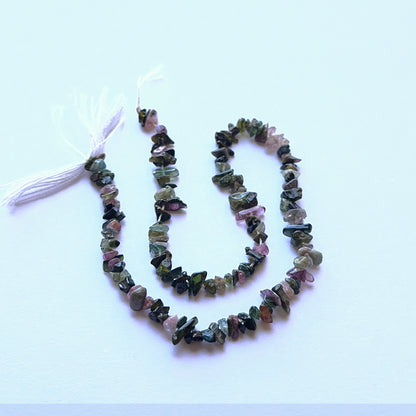 Close‑up of 4–5mm Tourmaline stone beads showing raw texture and organic shapes ideal for natural gemstone beads for DIY jewellery.