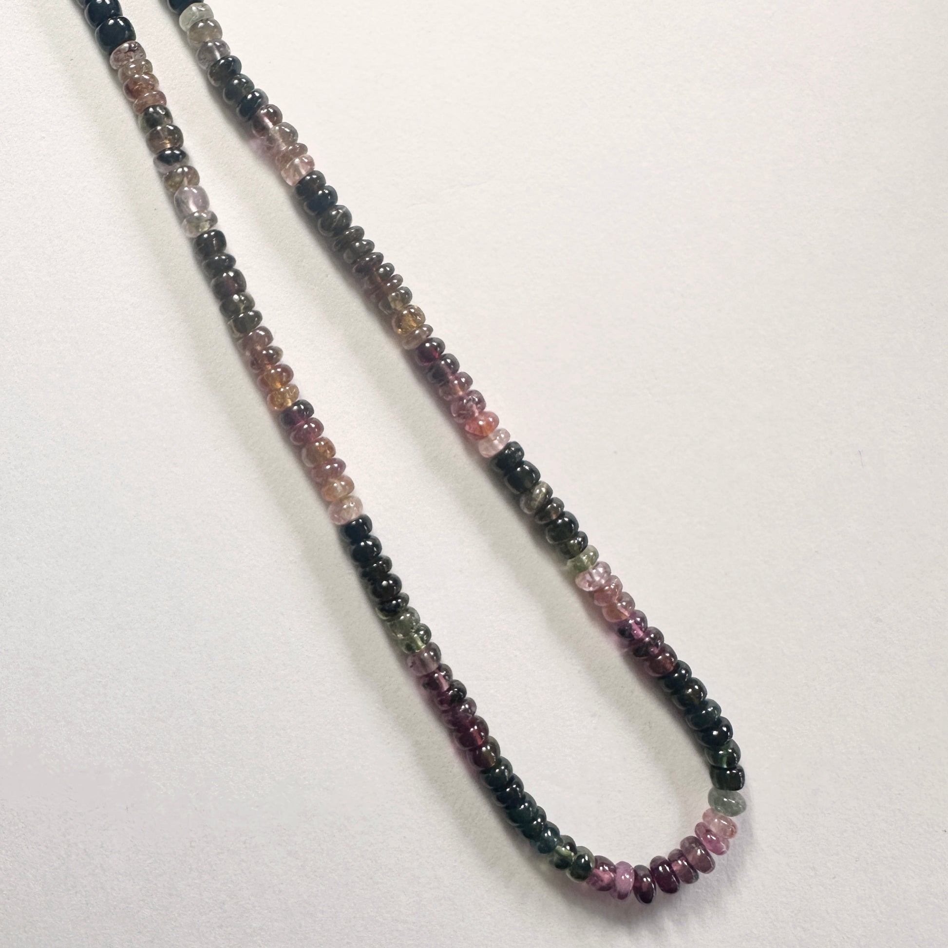 Premium tourmaline rondelle beads with polished texture and elegant multicolour tones.