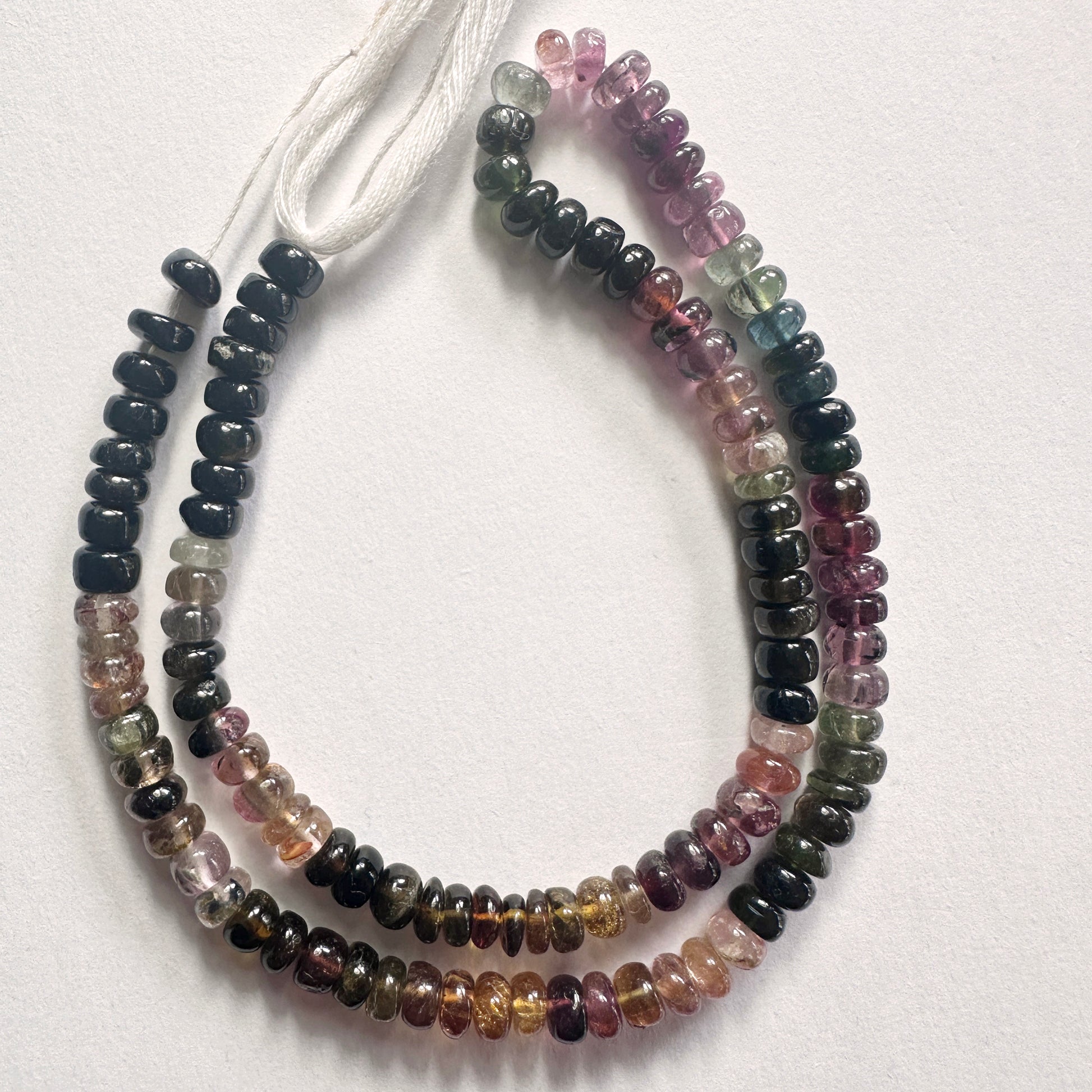 Tourmaline smooth rondelle beads in 5.5mm size arranged in a 37cm strand with polished finish and vibrant colour mix.
