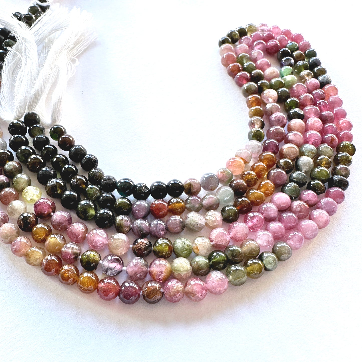 Natural gemstone beads for DIY jewellery featuring Tourmaline in earthy and pink hues with smooth finish.