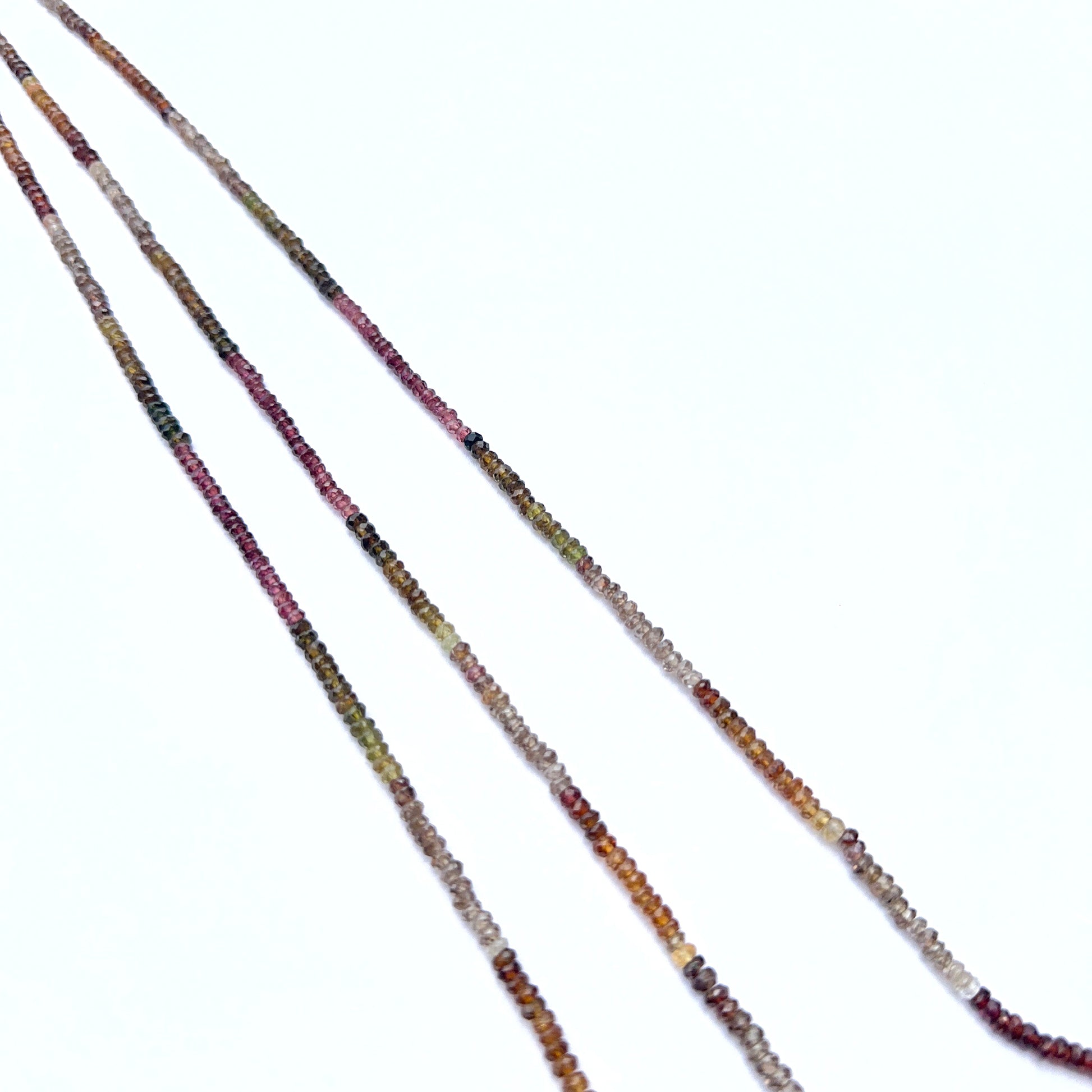 A delicate strands of tundra sapphire beads, showcasing their faceted design.