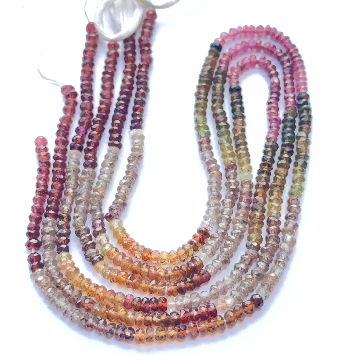 Close‑up of faceted tundra sapphire beads arranged on a strand.