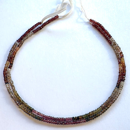 Tundra Sapphire faceted rondelle beads in 3.5mm size arranged in a 33cm strand with earthy tones and subtle sparkle.