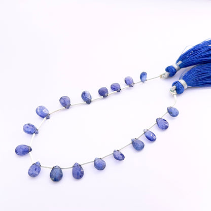 Close‑up of Blue Sapphire pear faceted almond 7–9mm beads highlighting crisp facets and intense sapphire colour.

