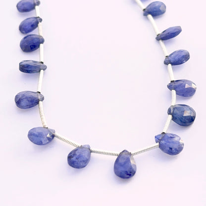 Set of 18 Blue Sapphire pear faceted almond beads 7–9mm totalling 33 carats, ideal for bespoke jewellery settings.
