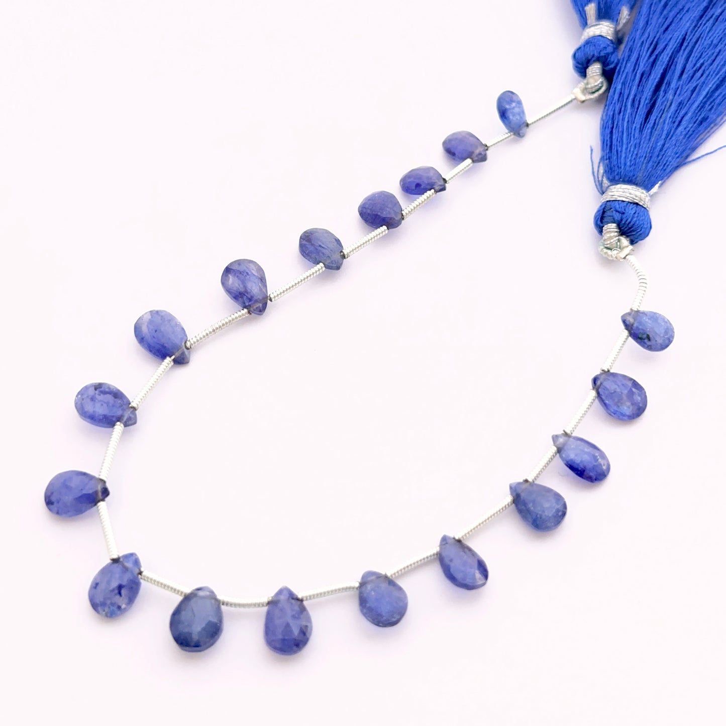Top side drilled Blue Sapphire pear faceted almond beads 7–9mm, perfect for elegant drop earrings and pendant designs.
