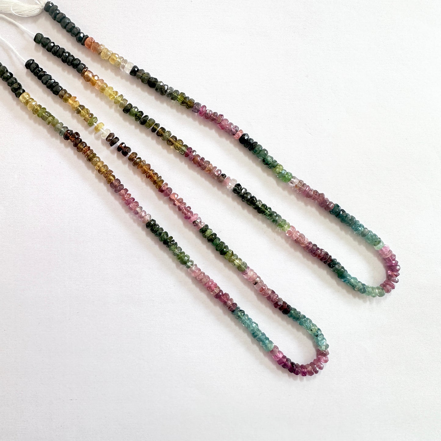 Multicolour Watermelon Tourmaline beads with faceted rondelle shape, reflecting light beautifully across the 34cm strand.