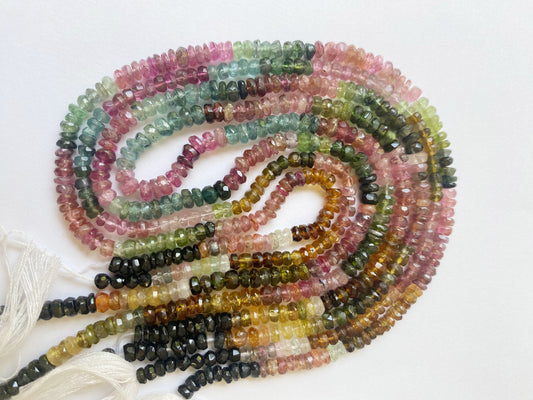 Natural Watermelon Tourmaline gemstones in rondelle cut, featuring a mix of translucent pinks and greens with brilliant luster.